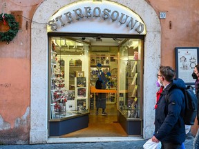 Pedestrians walk past the Stereosound record shop, located a few steps from the Pantheon in Rome, on January 12, 2022, a day after the Pope's visit.