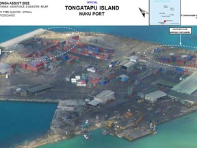This handout photo taken and released by the Australian Department of Defence on January 18, 2022 shows an aerial image from a reconnaissance flight taken during a mission by a Royal Australian Air Force P-8A Poseidon maritime patrol aircraft of damage to Nuku Port on the main island of Tongatapu in Tonga following the eruption of the Hunga Tonga-Hunga Haapai underwater volcano on January 15 and the subsequent tsunami.