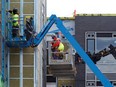 Construction workers work on a new apartment building in Ottawa in this May 27, 2021 file photo.