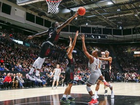 A 2020 file photo of a basketball game between the Carleton Ravens and Ottawa Gee-Gees men's teams. Ontario University Athletics is asking why athletes like these aren't considered "elite" under provincial pandemic restrictions.