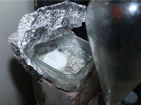 Investigators seized a plastic-wrapped container filled with a coarse gray powder, which police described as