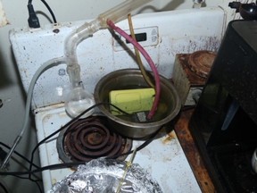 A photo of the alleged drug lab released by Ottawa police showed a maze of plastic tubes, pots and pans atop a stove.