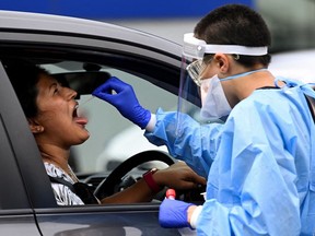 A woman takes a test for the coronavirus disease (COVID-19) at a testing centre in Sydney, Australia, January 5, 2022.