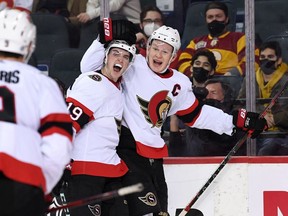 Ottawa Senators forward Drake Batherson (19) celebrates his second period goal with forward Brady Tkachuk (7) against the Calgary Flames at Scotiabank Saddledome.