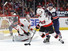 Ottawa Senators defenceman Thomas Chabot (72) clears the. Puck from in front of Senators goaltender Matt Murray (30) as Washington Capitals centre Aliaksei Protas (59) chases during the first period at Capital One Arena.