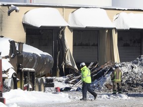 A photo taken Tuesday shows an investigator working at Eastway Tank five days after the explosion and fire.