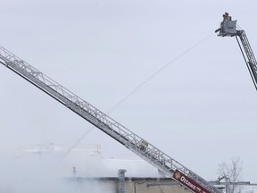 Fire crews work at Eastway Tank on Merivale Road in Ottawa Thursday afternoon following the explosion.