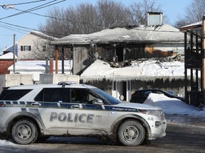 Gatineau police sit outside 190 Rue St-André in Gatineau Wednesday. Four people were injured in Wednesday's fire.
