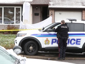 A Nov. 15 photo shows the Ottawa Police Service Homicide Unit investigating the scene at a house on Sherway Drive in Barrhaven.