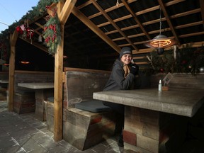 Elya Korylak, assistant general manager of Hunter's Public House, which has booths with individual heaters for outside dining.