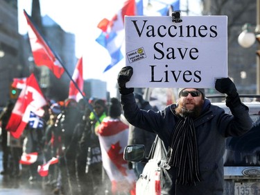 A couple hundred anti vaccine mandate protesters and truckers arrived on Wellington Street in Ottawa Friday afternoon. A pro vaccine supporter during Friday's protest.