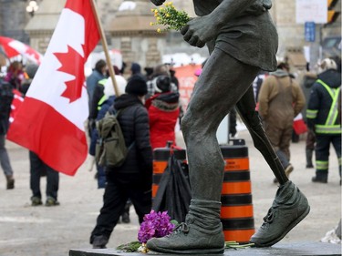 Anti vaccine mandate protesters and truckers still protesting on Wellington Street in Ottawa Monday morning. Terry fox was holding flowers instead of signs Monday morning.
