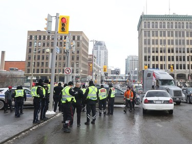 Ottawa Police officers on Wellington Street during a protest in Ottawa Monday morning.