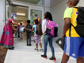 A September file photo shows teachers and students outside École Horizon-Jeunesse on the first day of school for elementary kids at the French Catholic school board.