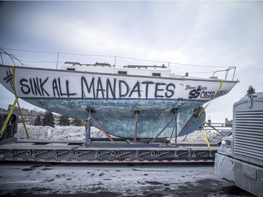 Trucks were parked, filling the Sir John A. Macdonald Parkway on Sunday, including a sail boat with "sink all mandates" painted on it.