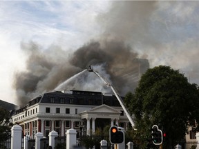 Firefighters work at the national parliament as the fire flared up again, in Cape Town, South Africa, January 3, 2022.