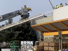 Ottawa firefighters rescue a worker from a Nepean rooftop Friday.