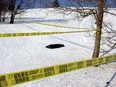 Police tape surrounds the toboggan Simon Lessard had been riding before he slammed into a tree in Lemoyne Park in February 2005.