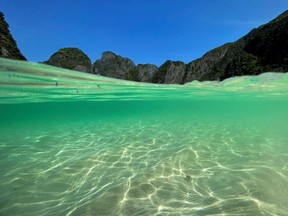 A partially underwater shot shows the waters at the beach of Maya Bay as Thailand reopens its world-famous beach after closing it for more than three years to allow its ecosystem to recover from the impact of overtourism, at Krabi province, Thailand, January 3, 2022. Picture taken January 3, 2022. REUTERS/Jorge Silva