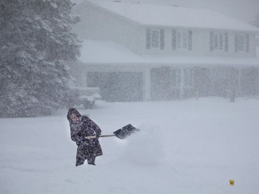 Heavy snow makes shoveling for Andra Morrison especially difficult in a Nepean neighbourhood.
