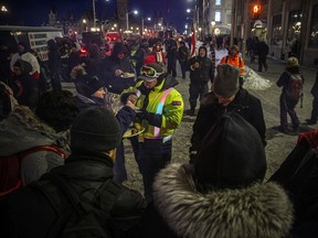 OTTAWA -- Thousands gathered in the downtown core for a protest in connection with the Freedom Convoy, Saturday, Feb. 5, 2022. BBQ meals were being handed out to protestors on Wellington Saturday evening.