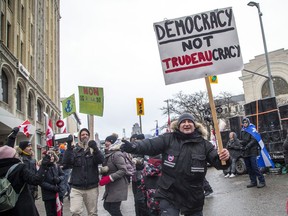 People gather at Sussex and Rideau on Sunday during the Freedom Convoy protest.