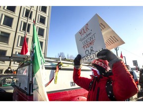 Ottawa residents opposed to the 'Freedom Convoy' confront a pro-convoy truck on Riverside Drive at Bank Street on Sunday.