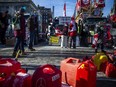 File: Gas tanks sat on the ground by the stage in front of Parliament Hill while protesters gathered as part of the "Freedom Convoy," Sunday, Feb. 13, 2022.