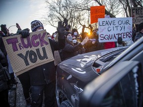 Ottawa counter-protesters turned the tables on a 'Freedom Convoy' on Riverside Drive at Bank Street, Sunday, stopping about 25 vehicles and holding up the convoy on day 17 of the protest in Ottawa.