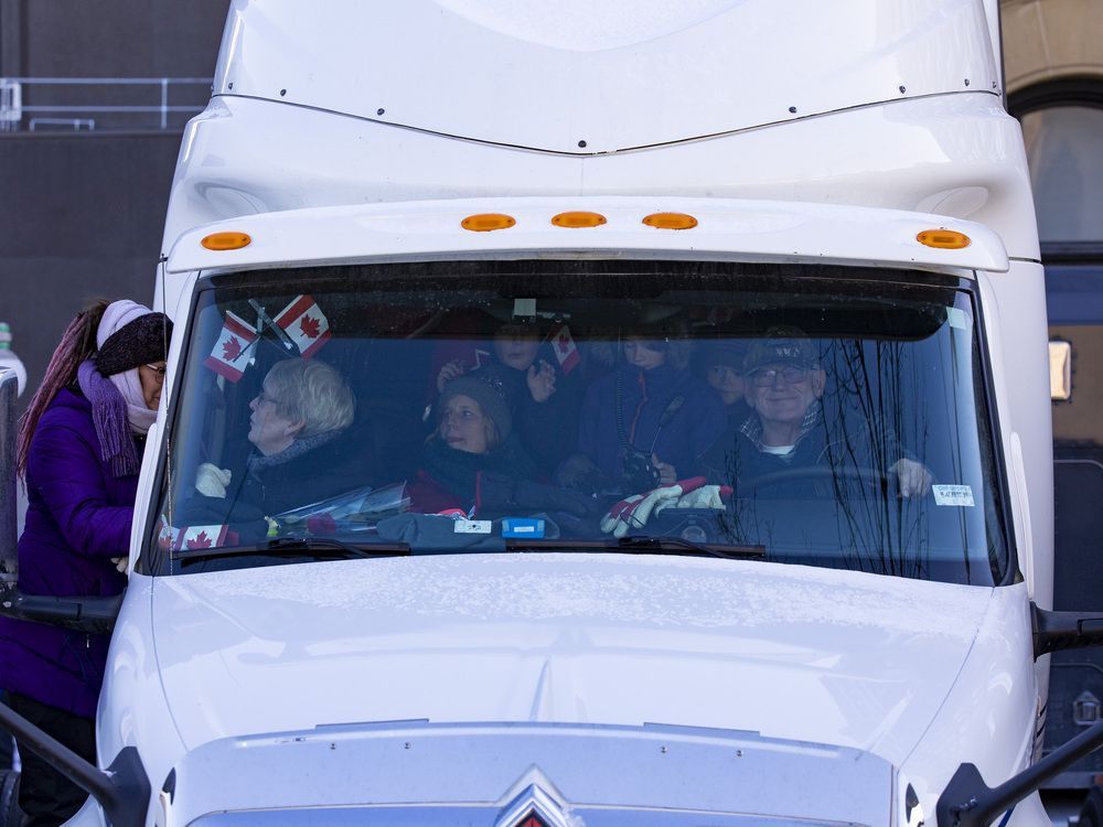 Anti-vaccine mandate protests continuing in downtown Ottawa. Police escort two trucks up to Wellington Street. Monday, Feb. 14, 2022.