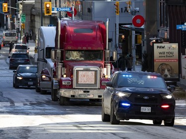 Anti-vaccine mandate protests continuing in downtown Ottawa. Police escort two trucks up to Wellington Street. Monday, Feb. 14, 2022.