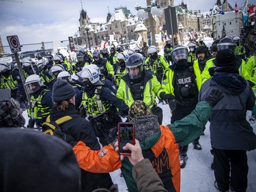 Police from all different forces across the country joined together to try to bring the "Freedom Convoy" occupation to an end Saturday, February 19, 2022. Police used paper spray and stun grenades as they moved west on Wellington Street Saturday.