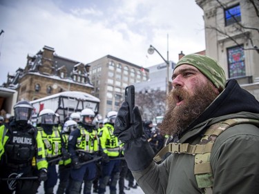 Police from all different forces across the country joined together to try to bring the "Freedom Convoy" occupation to an end Saturday, February 19, 2022. Some protesters stayed close to the police line, singing the national anthem and continuing chants of "Freedom."