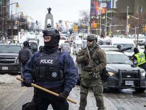 Police from different forces are shown working together on Elgin Street in downtown Ottawa on Sunday.