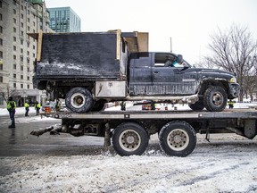 A truck being towed out of the downtown core Sunday.