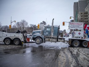 Trucks were being towed from the protest zone in downtown Ottawa Sunday, Feb. 20, 2022.