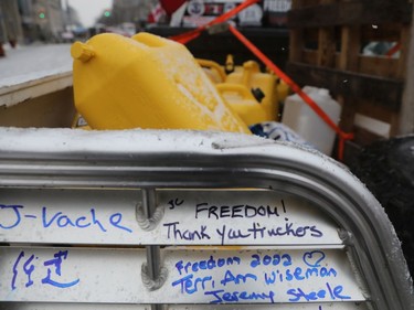 The trucker protest entered its 12th day in the capital Tuesday, a day after a judge granted an injunction against honking in downtown Ottawa. People sign a truck in support of the demonstration in front of Parliament Hill, downtown Ottawa on February 08, 2022.