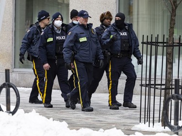 OTTAWA -- R.C.M.P. officers patrol Queen Street following the dispersal of anti mandate protesters that occupied the nation's capital for over three weeks. Monday, Feb. 21, 2022