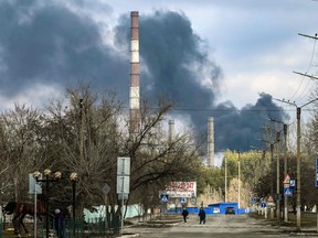 Smoke rises from a power plant after shelling outside the town of Schastia, near the eastern Ukraine city of Lugansk, on February 22, 2022. (Photo by ARIS MESSINIS/AFP via Getty Images)