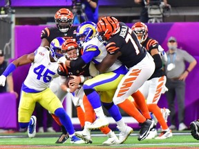 TOPSHOT - Cincinnati Bengals' quarterback Joe Burrow gets sacked during Super Bowl LVI between the Los Angeles Rams and the Cincinnati Bengals at SoFi Stadium in Inglewood, California, on February 13, 2022.