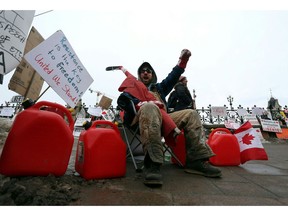 A man protests in front of Parliament Hill on Friday.