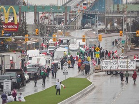 Anti-vaccine mandate protestors block the roadway at the Ambassador Bridge border crossing, in Windsor, Ontario on February 11, 2022.