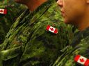 Canadian flag patches on the shoulders of the armed forces uniforms.