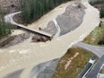 A swollen creek flows under a washed out bridge at the Carolin Mine interchange with Coquihalla Highway 5 after devastating rain storms caused flooding and landslides, near Hope, B.C.. Picture taken Nov. 17, 2021.