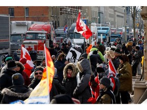 Truckers and supporters protest vaccine mandates and other restrictions in front of Parliament Hill, Feb. 1.