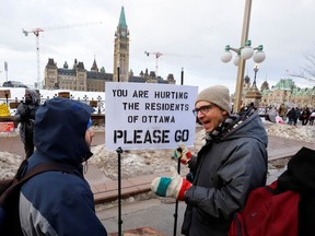 A counter-protester speaks as truckers and their supporters continue to protest in downtown Ottawa on Thursday.