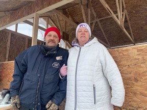 Bertrand Brunet and Tina Trealout stand outside the makeshift wooden "community kitchen" near Confederation Park.