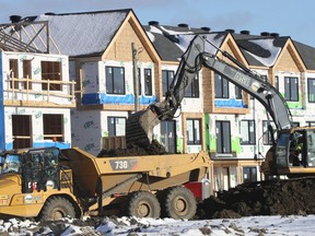 A construction crew works on new houses in Barrhaven.
