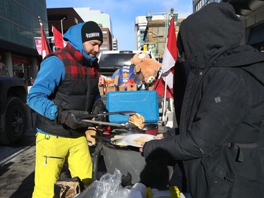 OTTAWA - Feb 1, 2022 - Anti vaccine mandate protesters and truckers protesting their fifth day in downtown Ottawa Tuesday. Jeremie Beauchamp cooks some breakfast for anyone who was hungry on Bank Street in Ottawa Tuesday.   TONY CALDWELL, Postmedia.