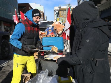 OTTAWA - Feb 1, 2022 - Anti vaccine mandate protesters and truckers protesting their fifth day in downtown Ottawa Tuesday. Jeremie Beauchamp cooks some breakfast for anyone who was hungry on Bank Street in Ottawa Tuesday.